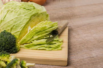 Fresh vegetables from the garden, cabbage, broccoli, onion and garlic on a wooden table
