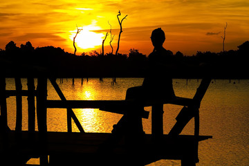 Fototapeta na wymiar Sunset and silhouette traveler