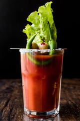 Bloody Mary Cocktail with green olive, pepper, lettuce, salt and ice. © Alp Aksoy