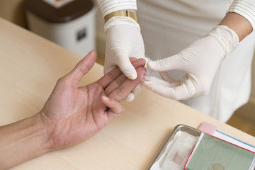 Fototapeta na wymiar Close up of nurse hands doing blood testing