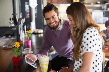Portrait of a man and women using digital tablet 