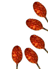 Red caviar and spoons isolated on background