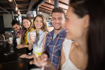 Group of friends having drinks in restaurant