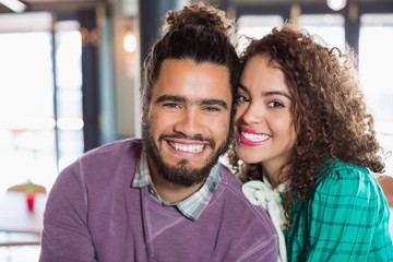 Portrait of cheerful young couple at restaurant