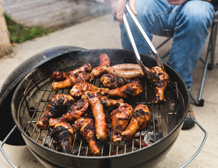 Man Grilling Meats on BBQ Grill