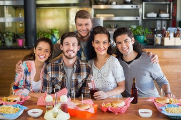 Smiling friends enjoying in restaurant