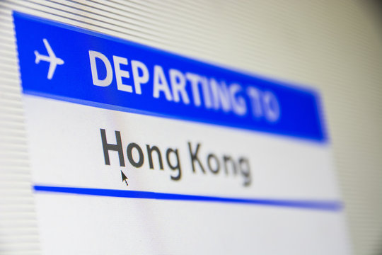 Computer screen close-up of status of flight departing to Hong Kong, China