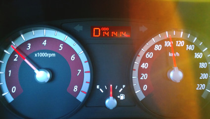 Car dashboard while driving at high speed - a nice number on the odometer, the bright glare of the...