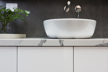 Close up of bathroom basin on a marble top vanity