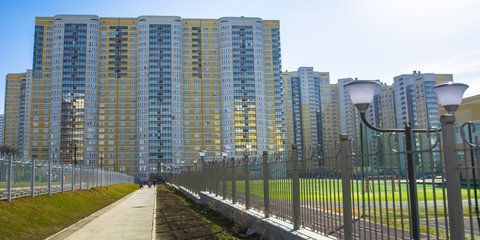 The facade of the new residential high-rise buildings against the sky . The concept of building a typical residential neighborhood