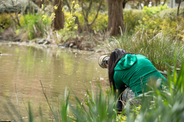 A professional photographer shooting a duck with a newborn ducks 