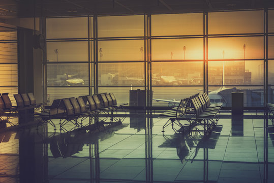 Silhouette of an empty airport terminal during sunrise. Travel Concept. Vintage colors