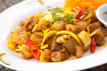 Fried sauteed beef tendon with onion and chili on white dish