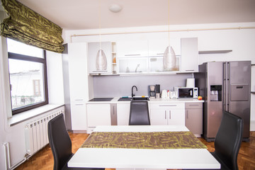 Chairs and table and kitchen in a dining room