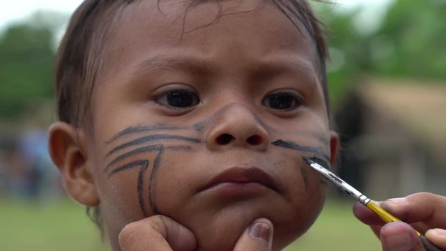 Painting a Face of Native Brazilian Children (Indio) - Brazil