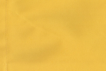 Yellow canvas textured background or wallpaper from rough fabric and a blank space