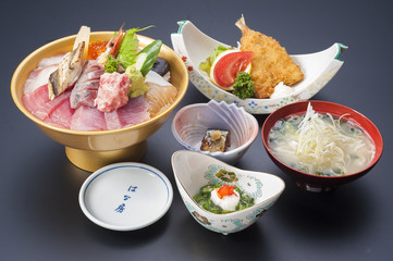 Sushi meal with fresh sashimi tuna, fried fish and onion soup