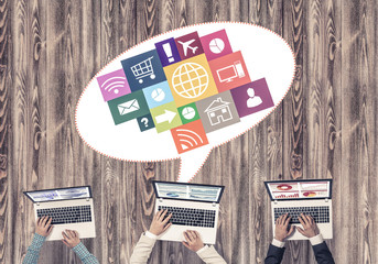 Top view of businesspeople sitting at table and using gadgets