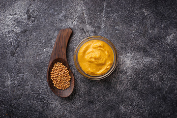 Fototapeta premium Mustard and seeds on concrete background