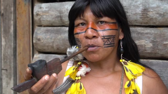 Indigenous Woman Smoking Pipes in a Tupi Guarani Tribe, Brazil