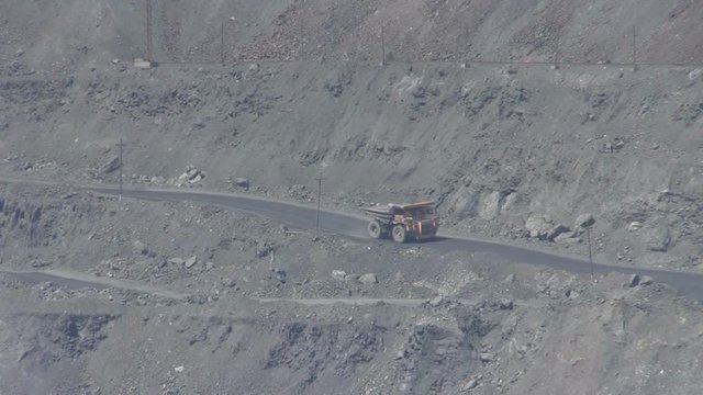 quarry extracting iron ore with heavy trucks, excavators, diggers and locomotives