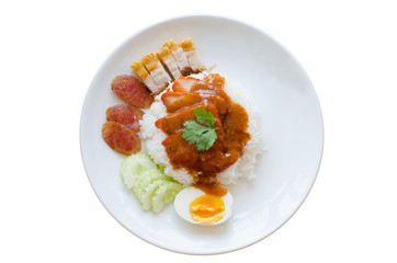 Barbecued red pork and crispy pork in sauce with rice isolated on white background