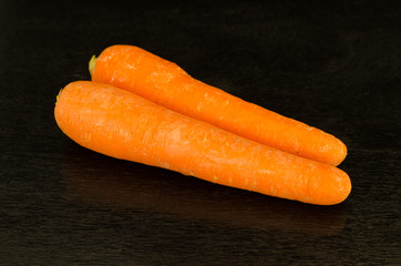 fresh carrot on black wooden background