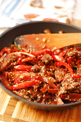 Sauteed beef with red chili in black pan