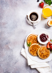 Healthy breakfast background with homemade pancakes and fresh berries, copy space, top view.