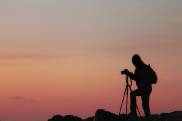Seascape with sunset and rocks in a calm sea water. Natural landscape