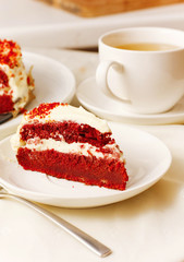 Cakes and biscuits with cream and tea on white platter