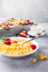 Healthy breakfast with cereal balls, fresh milk and berries, selective focus.