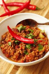 Chilli with minced  beef and herbs on white bowl