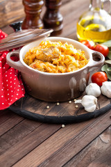 Stewed cabbage with meat on dark rustic wooden background