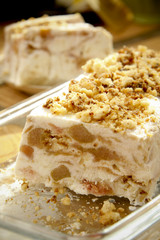 Creamy tart with chestnut on glassy tray on table