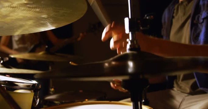 Drummer playing drum in studio