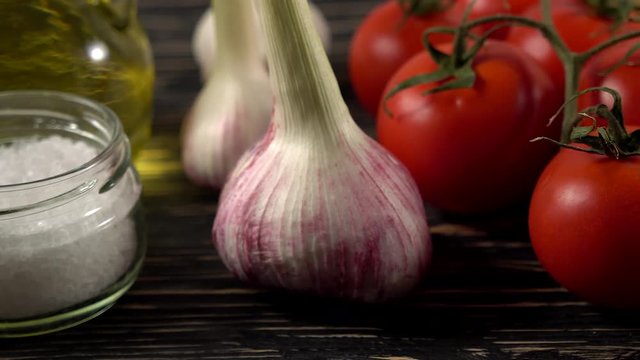 pasta, oil, tomatos and garlic on wooden background