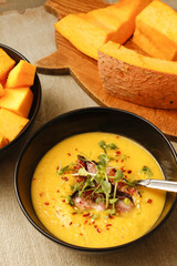 Pumpkin and lentil soup with crispy bacon