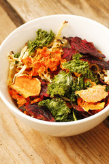 Oven cooked vegetable chips with lettuce, potatoes, basil and herbs