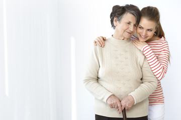 Granddaughter standing behind her grandma
