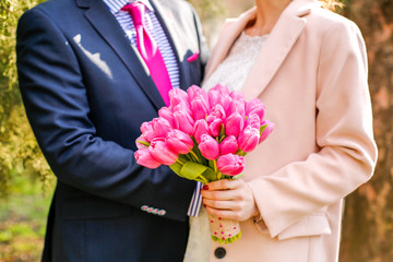 Closeup of couple with tulip bouquet