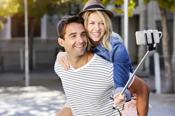 Smiling happy couple messing about for selfie