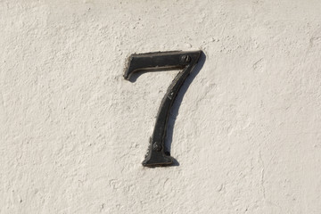 House number 7 sign on wall