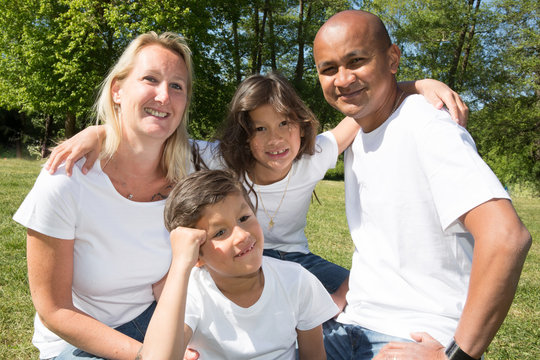 multiracial family in the park in the summer day