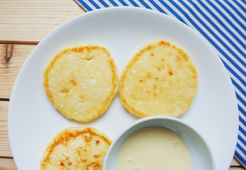 Russian style breakfast syrniki or cottage cheese pancakes.
