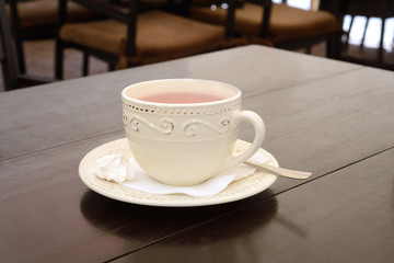 Cup of ginger tea on a table at restaurant