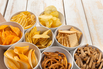 Pretzels in bowls on wooden table from above