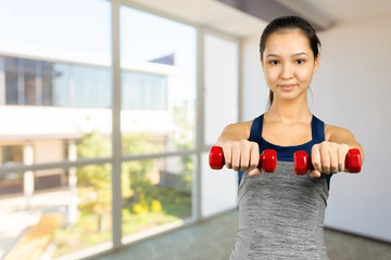 Fitness girl - attractive young woman working out with dumbbells