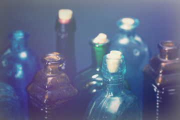 Old colourful bottles against a dark background