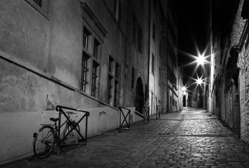 lluminated alley with an old bicycle in Vieux Lyon, the old town of Lyon, France.